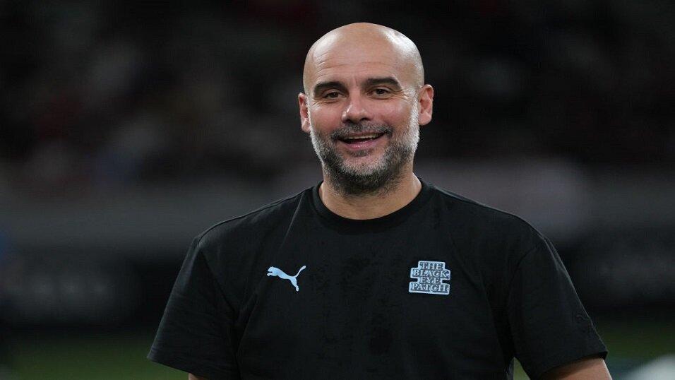 Man City manager Pep Guardiola smiling in pre-season